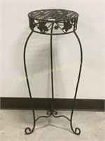 Wrought iron plant stand with decorative base