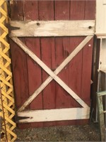 Three old barn doors all have some damage