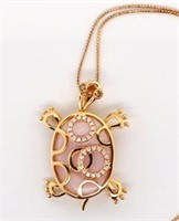 Diamond, mother of pearl and gold turtle pendant.