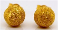 Gold stud earrings.