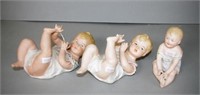 Three bisque piano dolls