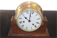 Brass ships clock in wooden holder with key