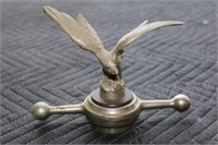 Hood ornament of an eagle marked Foss Hughes Co