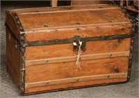 Antique Hump Back Trunk with papered interior.