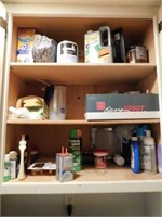 Three shelves with Singer sewing machine oil cans