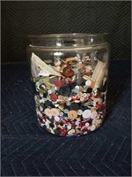 Big glass jar full of buttons
