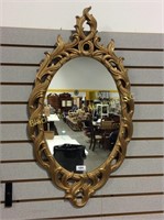 Uniquely framed oval mirror