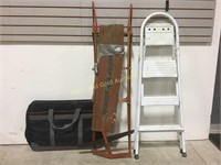 Step ladder, old wooden sleigh and travel bag