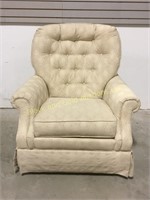 Cushioned white swivel rocking chair