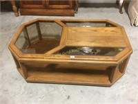 Wood and glass coffee table on wheels