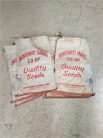 Eight Montgomery Farmers Co-op Seed Bags