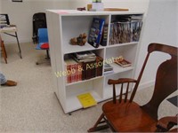 Two wood bookcases (wheeled) with books