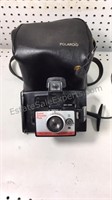 Vintage Polaroid camera with bag