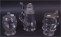 Two glass tankards with lids, 6" and 8",