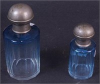 Two dark blue-to-clear perfume bottles