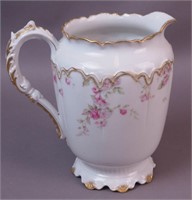 A 9" porcelain water pitcher marked