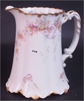 An 8" china water pitcher marked Haviland