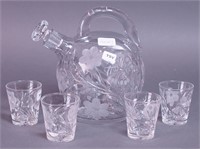 A cut glass bulbous wine pitcher with stopper,