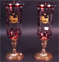 A pair of glass hurricanes with ruby
