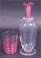 A clear bedside carafe with ruby threaded