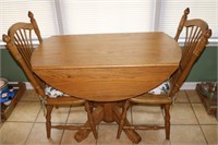 Oak dinette set with two chairs and cushions