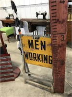 Men working floor stand sign w/76 checker flag