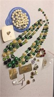 2 necklaces and several pins