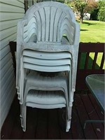 White plastic chairs (8)