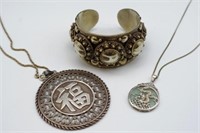 Two oriental silver pendants on chains