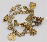Vintage gilt bracelet with various gold charm