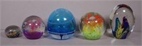 Five glass paperweights