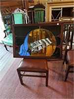 Framed stained glass ship listing