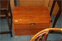 Light wood chest with brass covers and handles