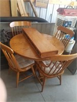 round oak dining table w/ 1 captains chair. +
