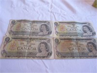 Four Canadian $1 dollar bills