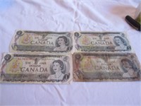 Four Canadian $1 dollar bills
