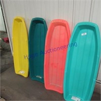 4 plastic sleds