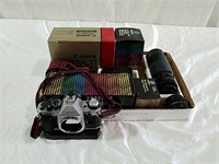 Canon 35 millimeter camera with lenses and boxes