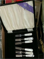 Box of silverware and silver handle cake knife