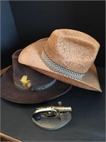 Two cowboy hats and a flintlock pistol lighter.