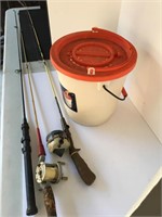 Vintage fishing poles with bait bucket.