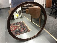 Round mahogany wall mirror; brown mahogany wall
