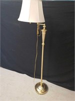 Brass colored adjustable arm floor lamp. Tested