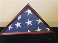 American flag in wood and glass display case.