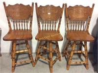 3 wooden swivel chairs