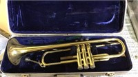 Brass trumpet with a mouthpiece and a blue velvet