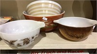 Four Pyrex glass mixing bowls all different brown
