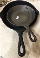 Two cast-iron skillets, a Griswold number five,