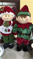 Two Christmas decorations,  elf and Mrs. Santa