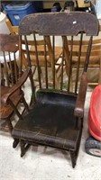 Antique wood rocking chair with arms and some